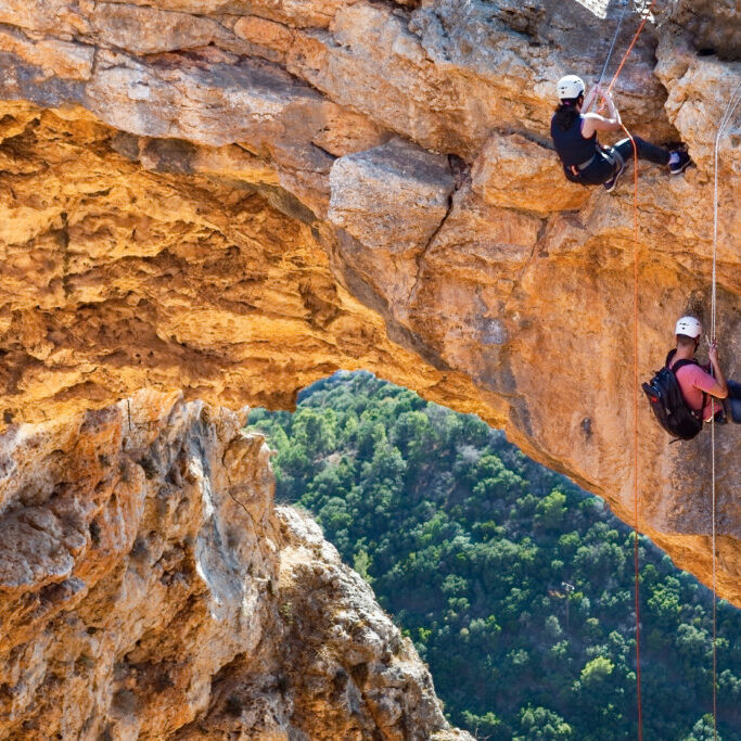 portrait of climbers descending from a rainbow cave in Western G
